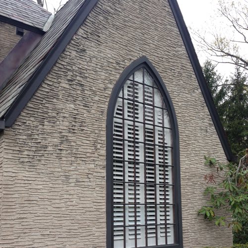 outside face of brick home with plantation shutters